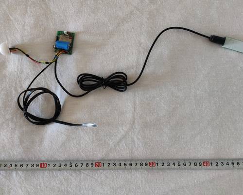 Electronic filling of the climate sensor. Central on the top is a board with a battery and a transmitting antenna, on the right side is a soil moisture sensor, on the left side — a light sensor. 
Below in the center is a remote (in this assembly) temperature sensor